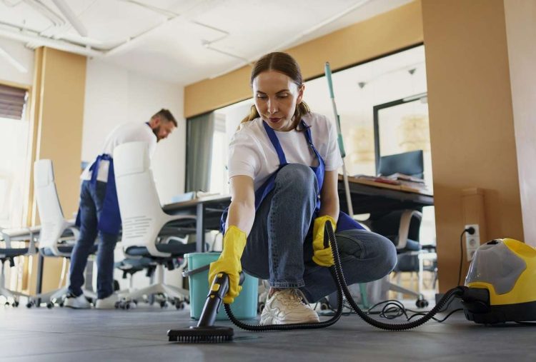 professional-cleaning-service-person-using-vacuum-cleaner-office